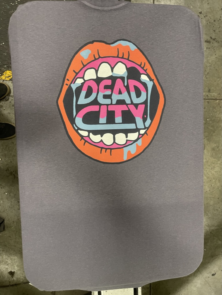 Screen Printed T shirt of open mouth saying dead city done for Jungmaven on hemp tees
